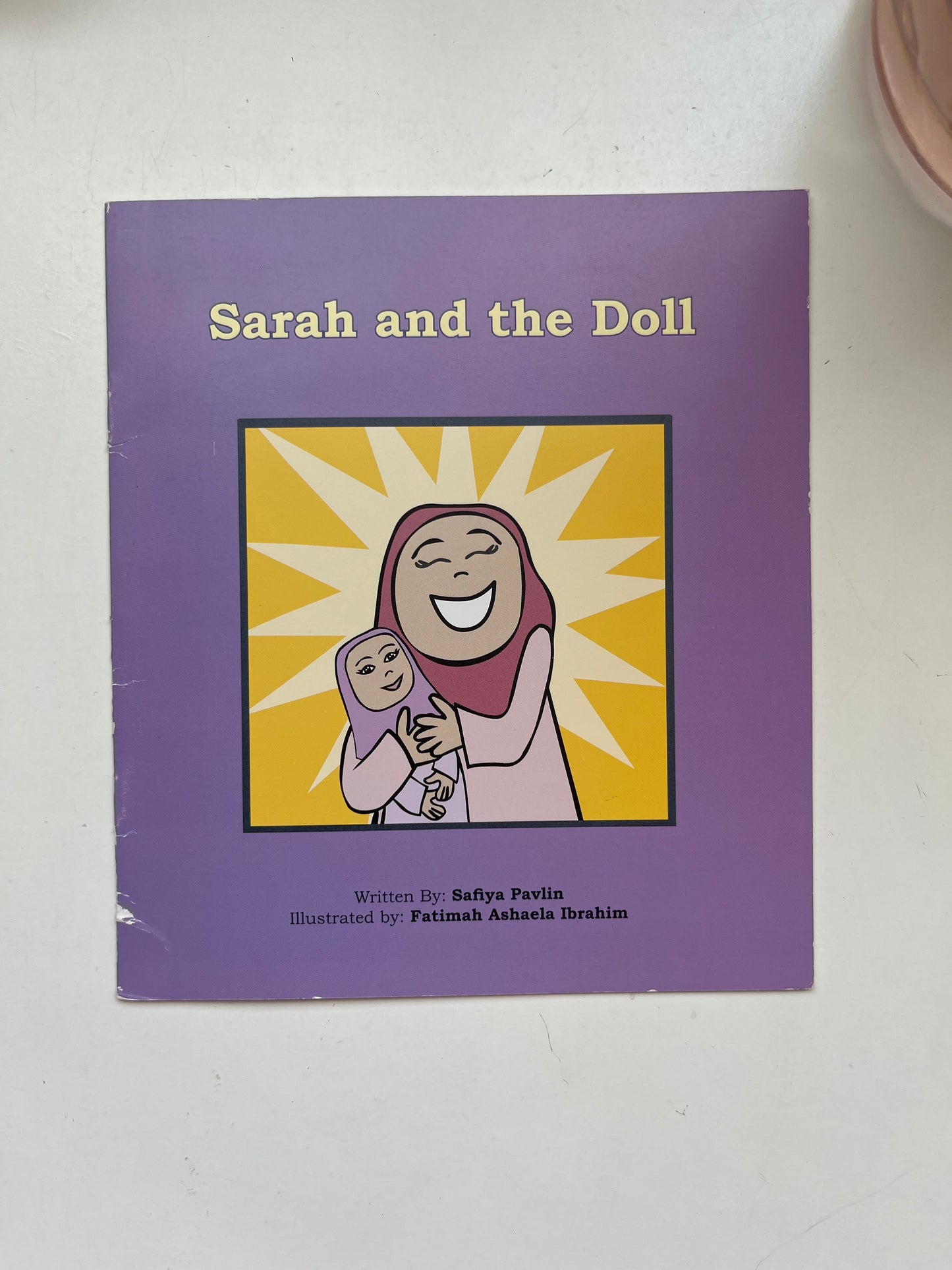 Cover of Sarah and the Doll featuring a young girl and her beloved toy in pastel tones.