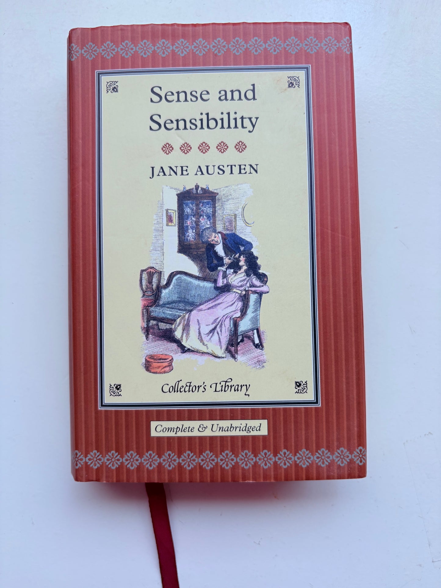 Book titled 'Sense and Sensibility' by Jane Austen on a white background