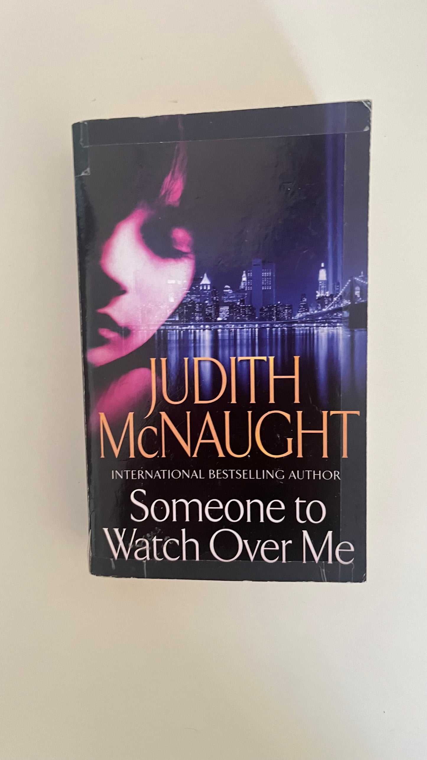 Paperback of Someone to Watch Over Me by Judith McNaught, featuring an intense and suspenseful cover design.

