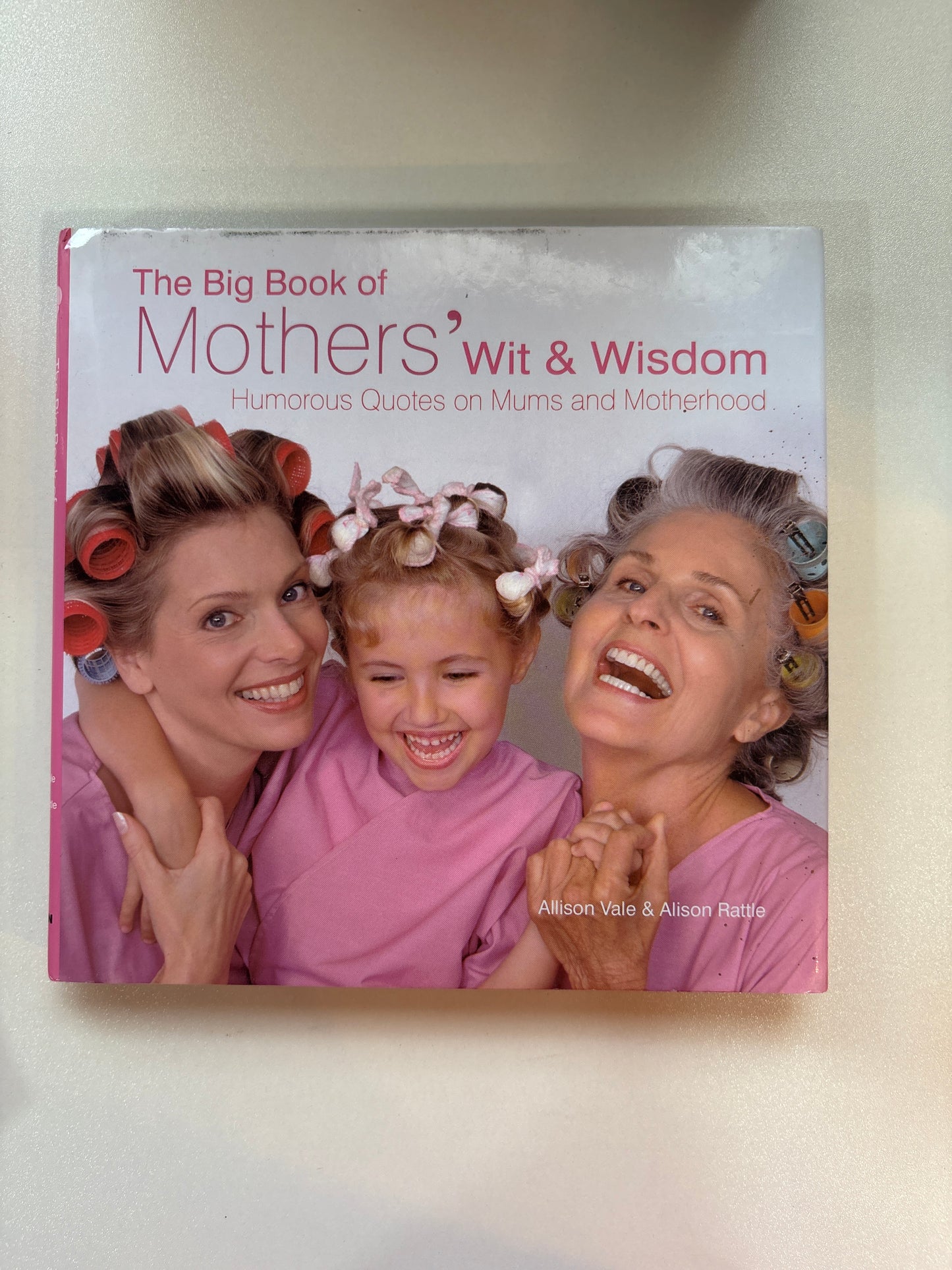 Book titled 'The Big Book of Mother's Wit & Wisdom' on a light background
