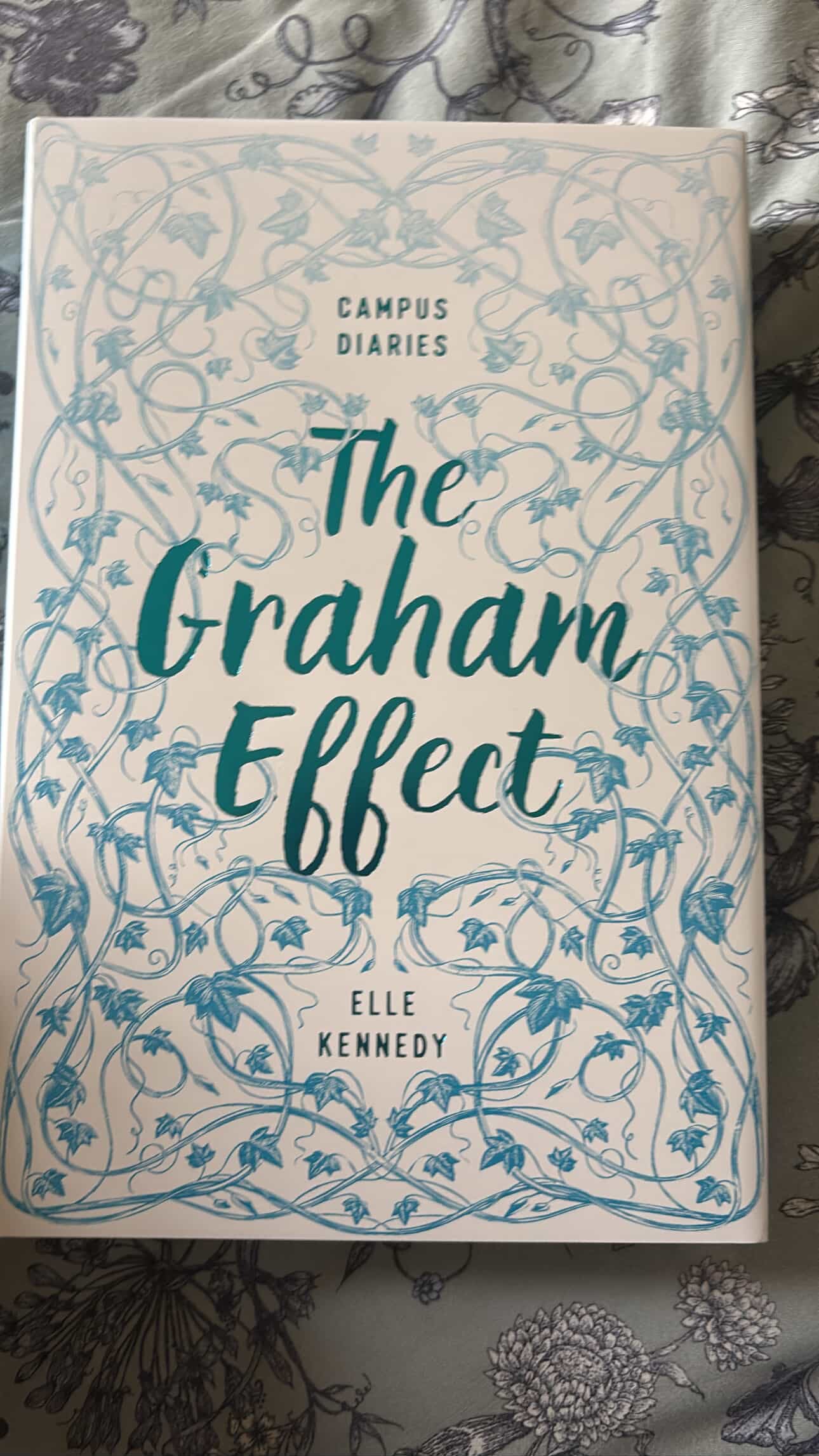 Book titled 'The Graham Effect' by Elle Kennedy with decorative cover on a patterned background
