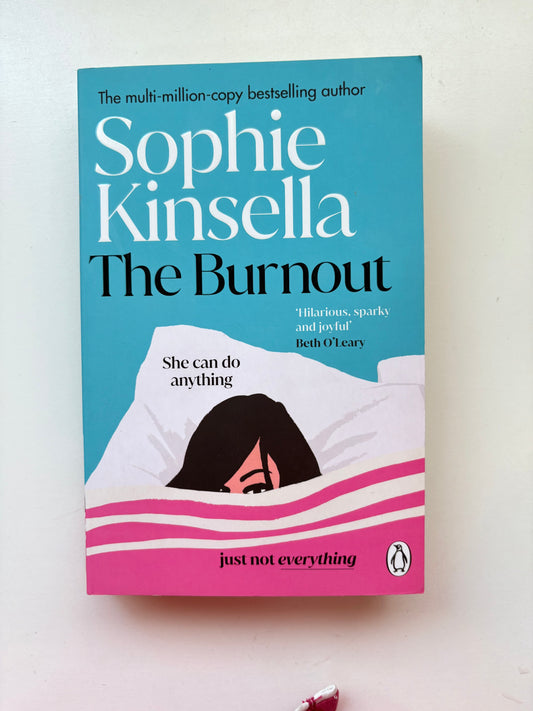 Book cover of 'The Burnout' by Sophie Kinsella with a blue and pink design.