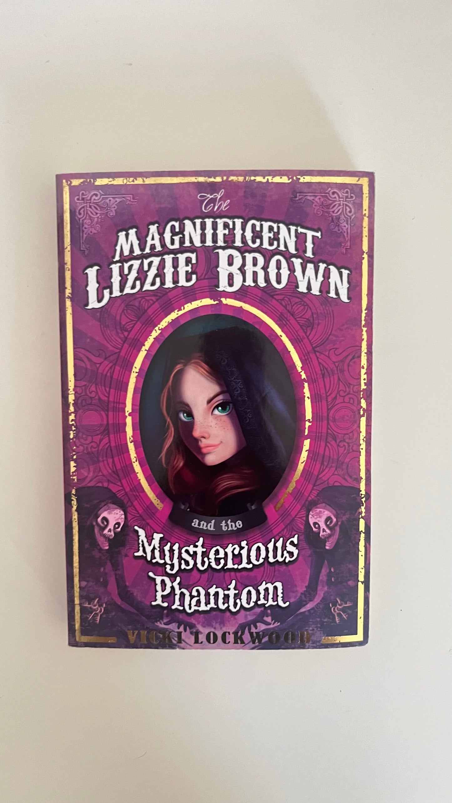Paperback edition of The Magnificent Lizzie Brown by Vicki Lockwood with a vintage-style circus-themed cover.

