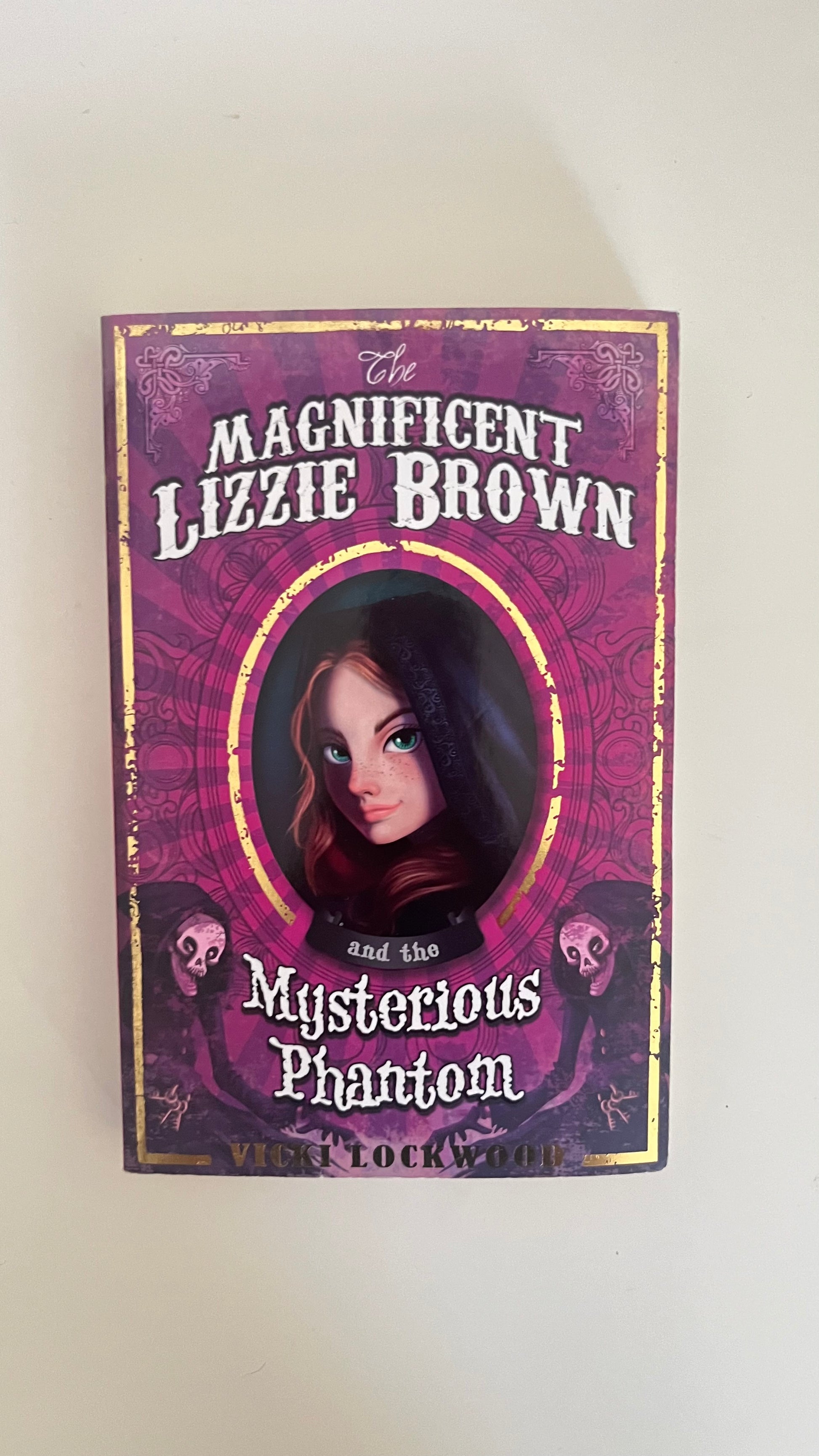 Paperback edition of The Magnificent Lizzie Brown by Vicki Lockwood with a vintage-style circus-themed cover.

