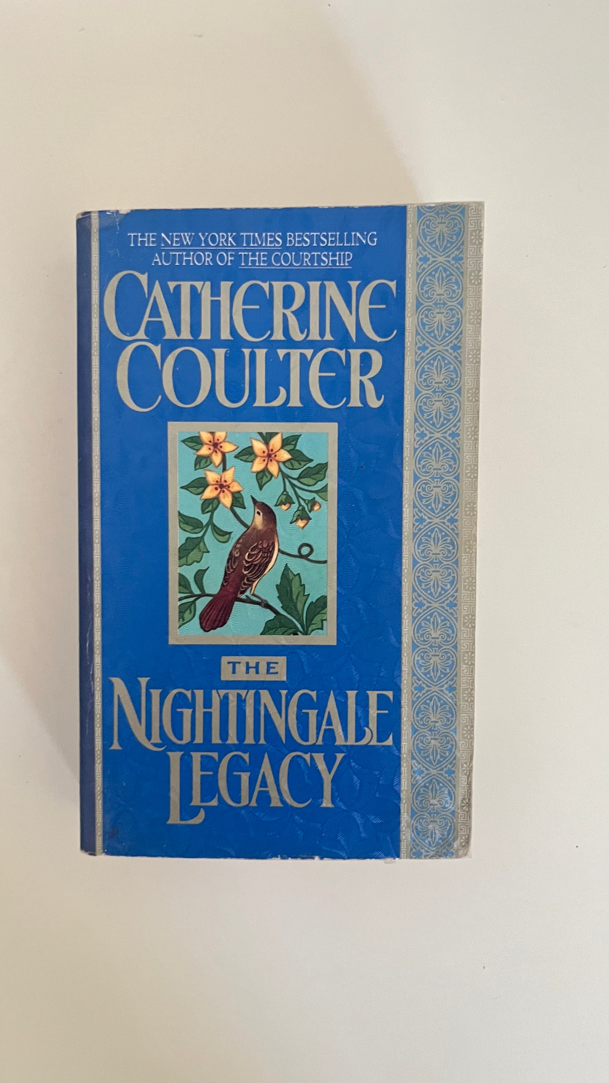 Paperback edition of The Nightingale Legacy by Catherine Coulter with a gothic mansion and moonlit backdrop.

