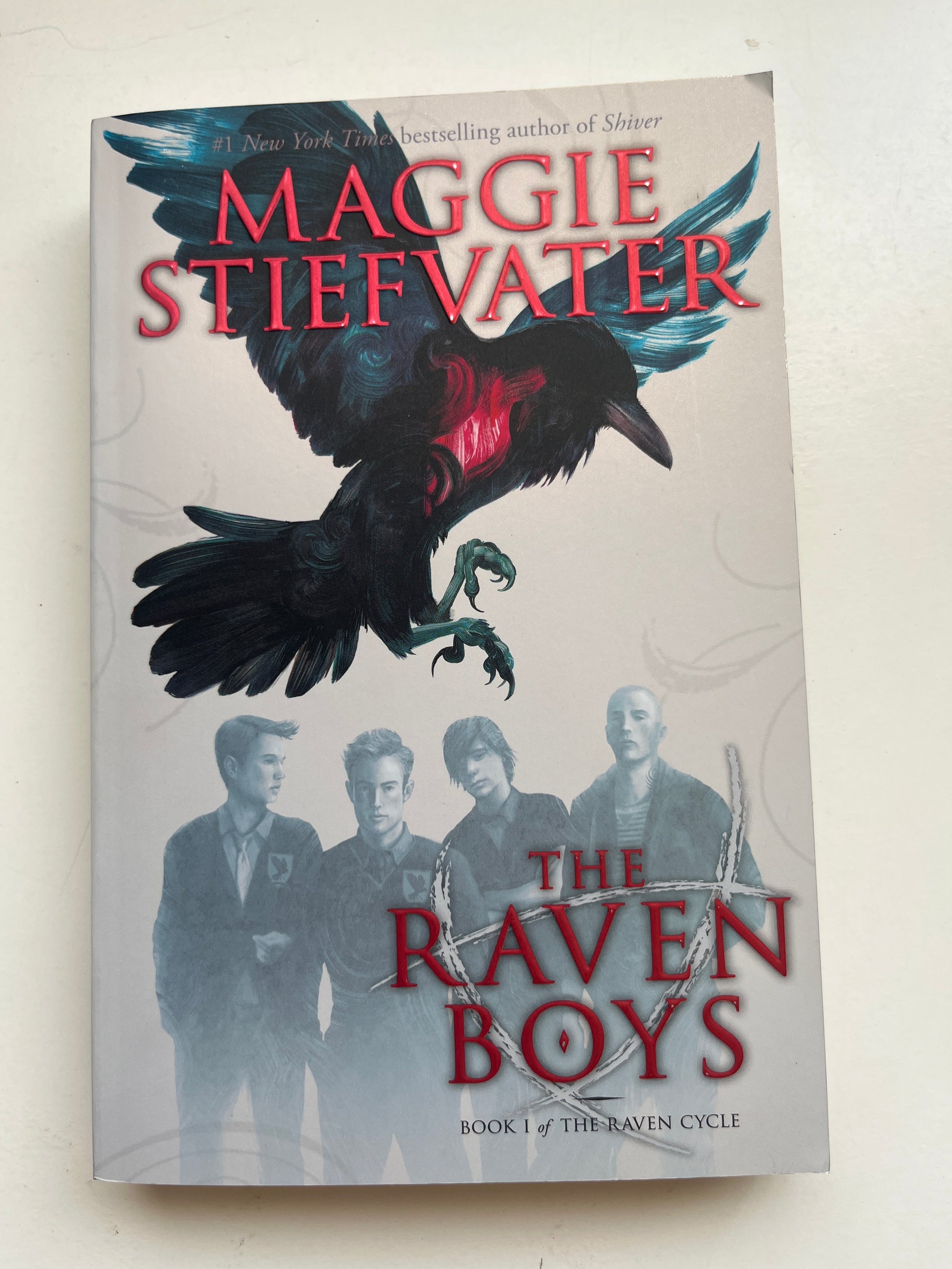 Cover of The Raven Boys by Maggie Stiefvater, featuring ravens and magical themes.