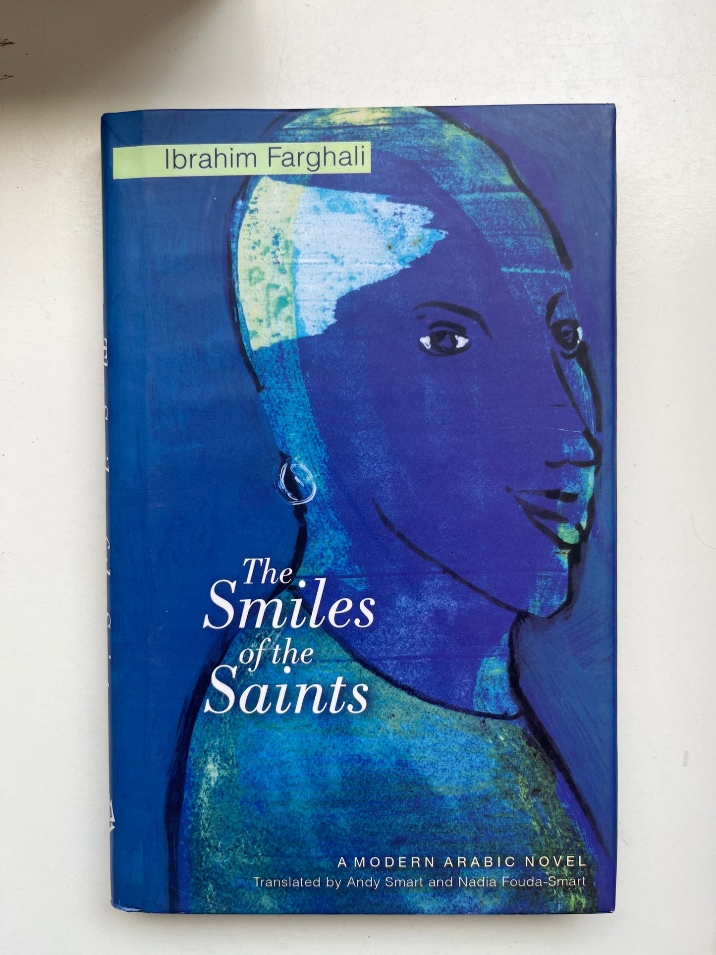 Paperback of The Smiles of the Saints with old-world religious artwork and vintage tones.

