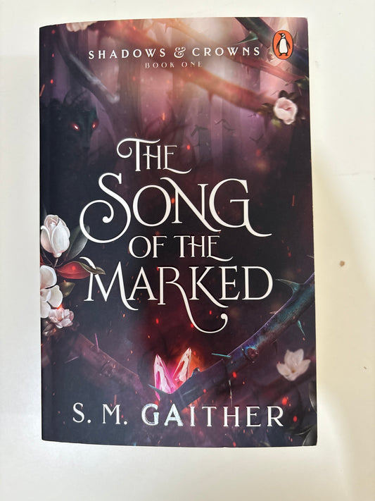 Book titled 'The Song of the Marked' by S.M. Gaither on a white background