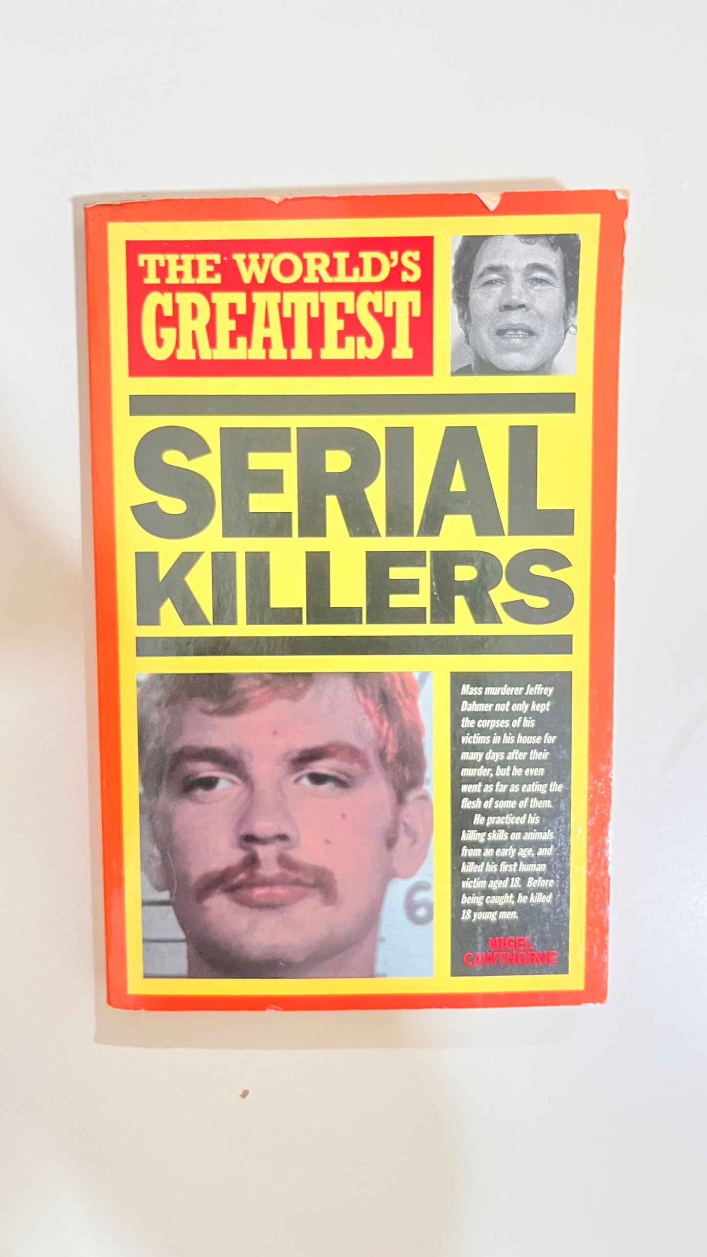 Dark and gritty cover of The World’s Greatest Serial Killers, featuring notorious criminal profiles.

