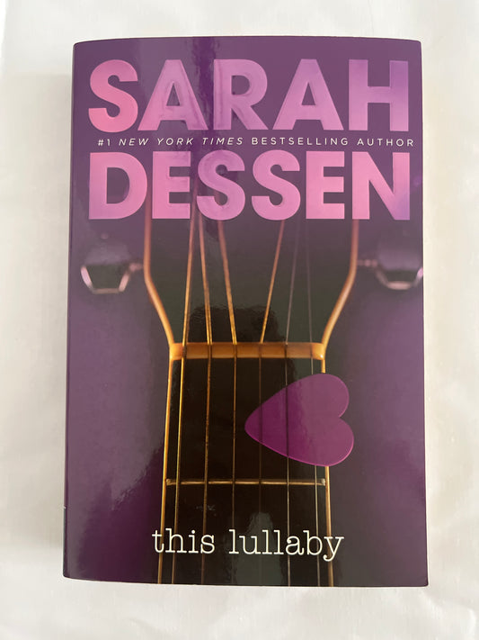 Cover of This Lullaby by Sarah Dessen with a dreamy pastel color scheme and a guitar as a central motif.