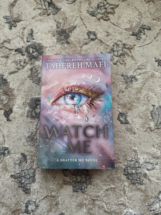 Book titled 'Watch Me' by Tahereh Mafi on a textured surface