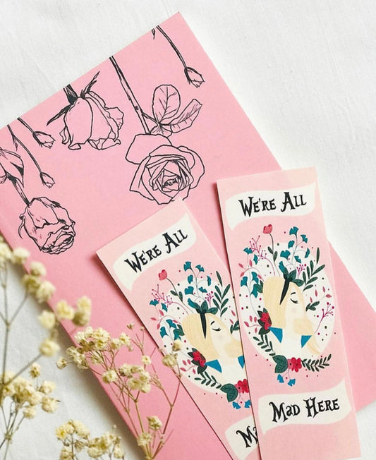 Bookmark with "We’re All Mad Here" quote and whimsical design