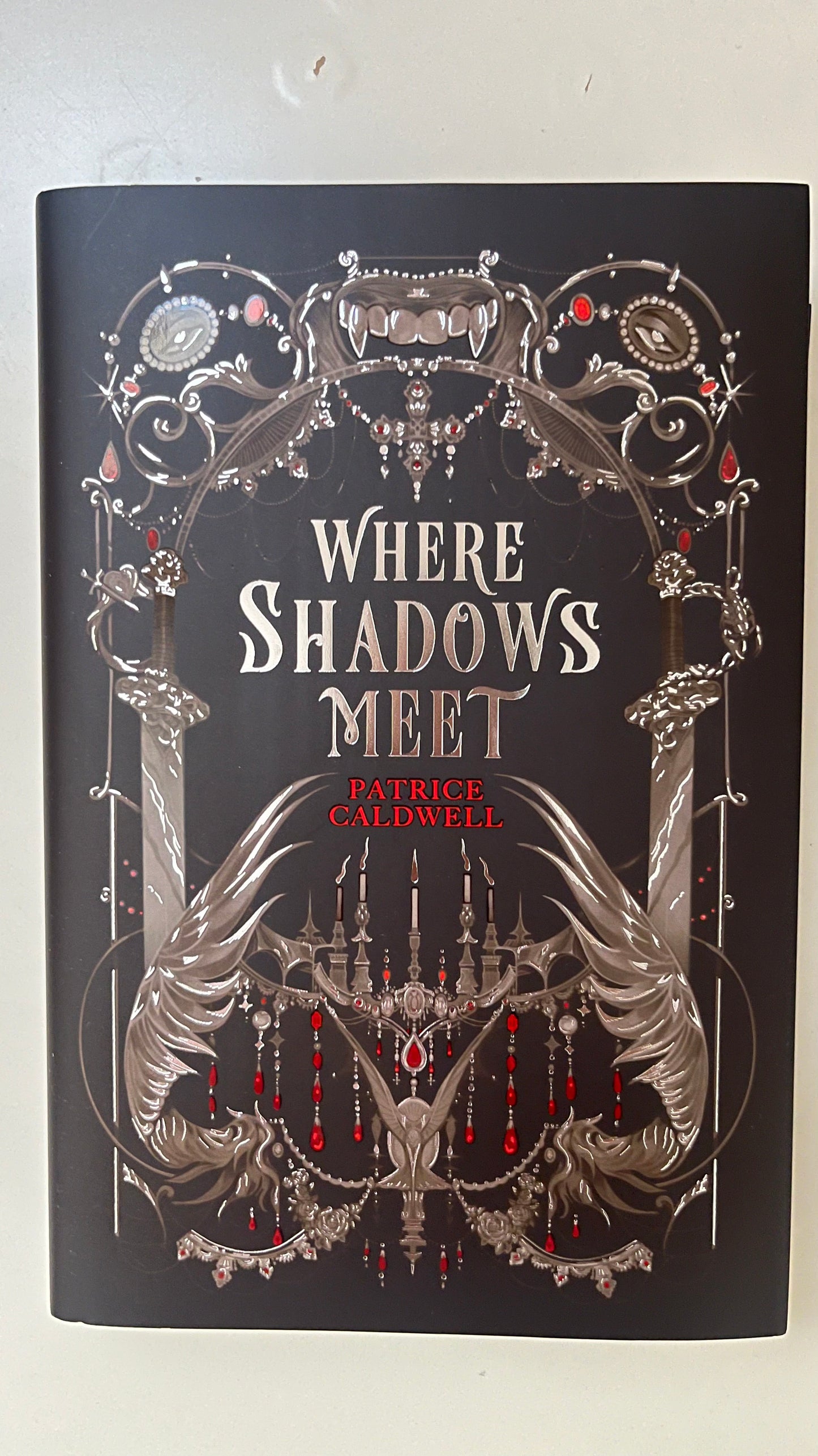 FairyLoot edition of Where Shadows Meet by Patricia Caldwell featuring custom cover design, sprayed edges, and exclusive collector's details.