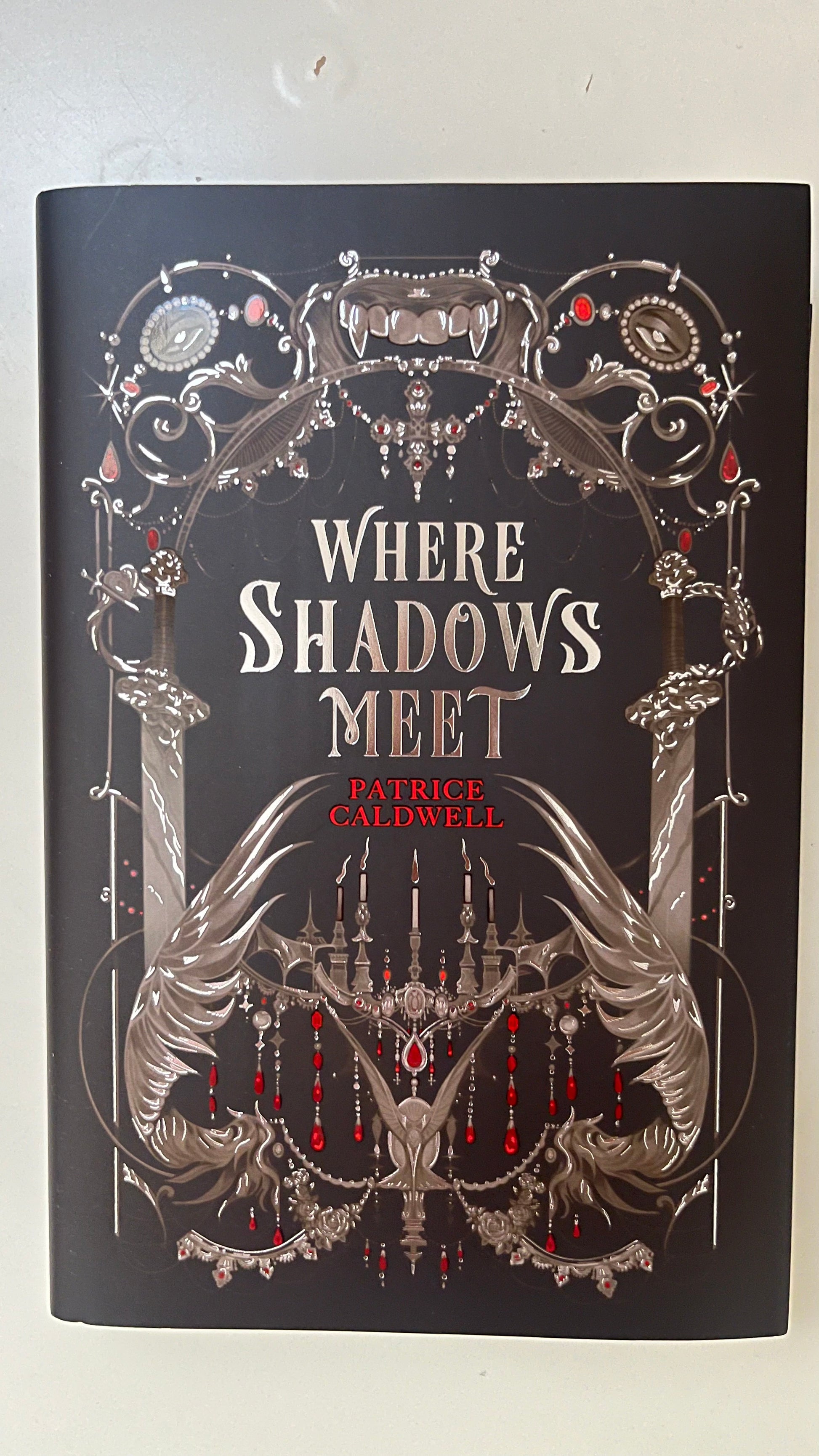 FairyLoot edition of Where Shadows Meet by Patricia Caldwell featuring custom cover design, sprayed edges, and exclusive collector's details.