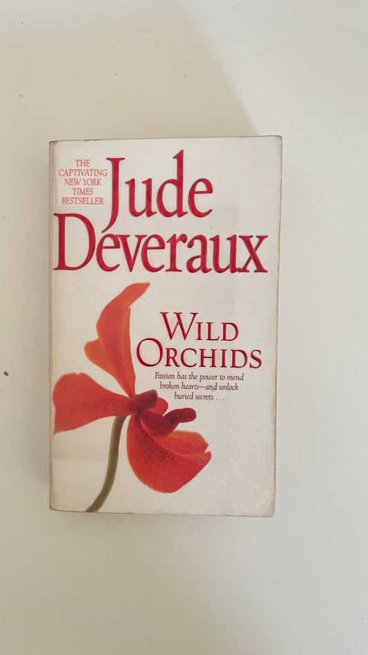 Paperback edition of Wild Orchids by Jude Deveraux featuring a lush, floral design hinting at passion and secrets.

