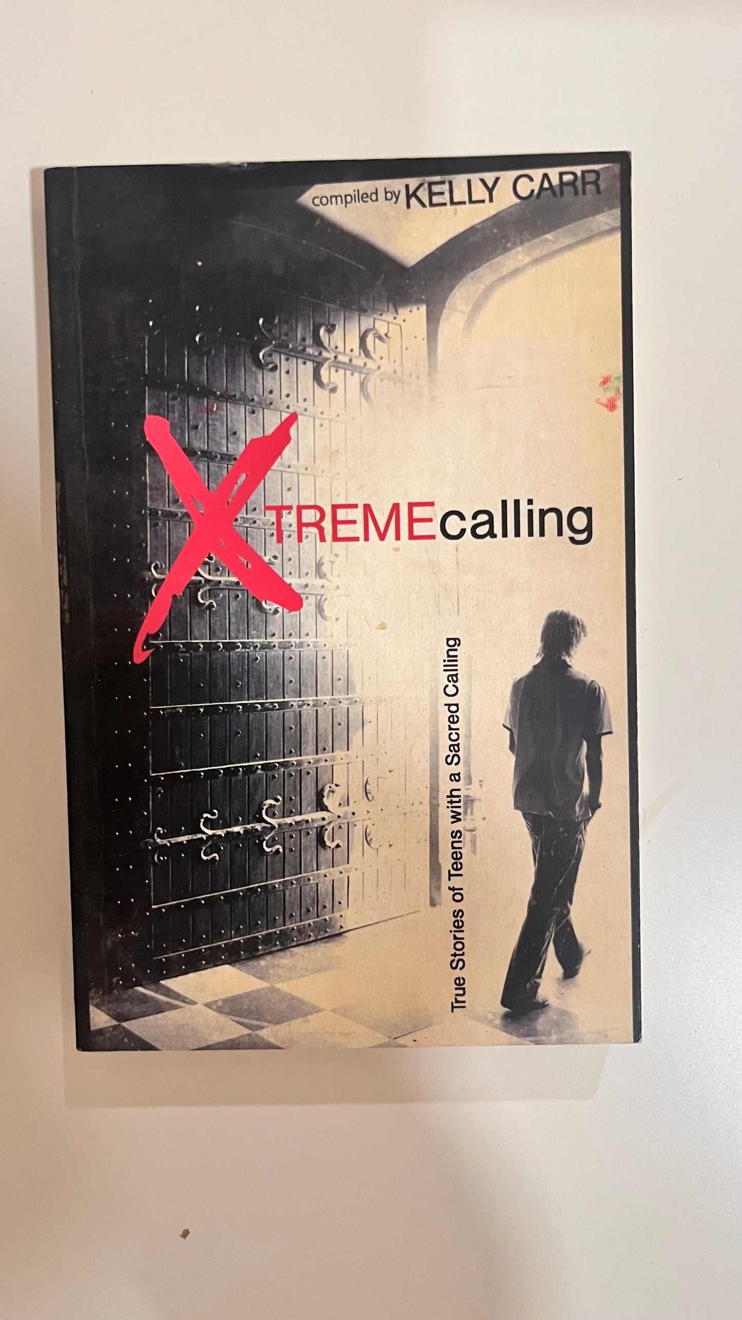 Paperback of Xtreme Calling with intense, adrenaline-fueled cover art featuring elements of danger and survival.

