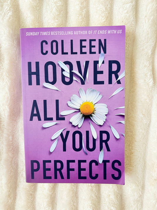 Purple book cover with a daisy and text on a textured beige background