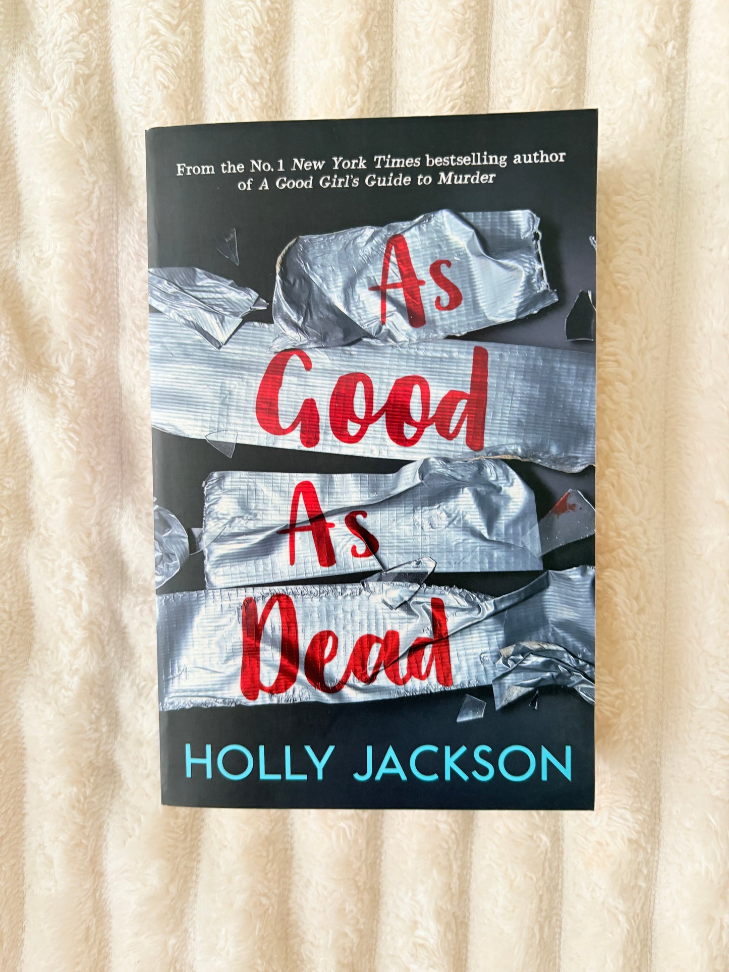 Book cover of 'As Good As Dead' by Holly Jackson on a textured surface