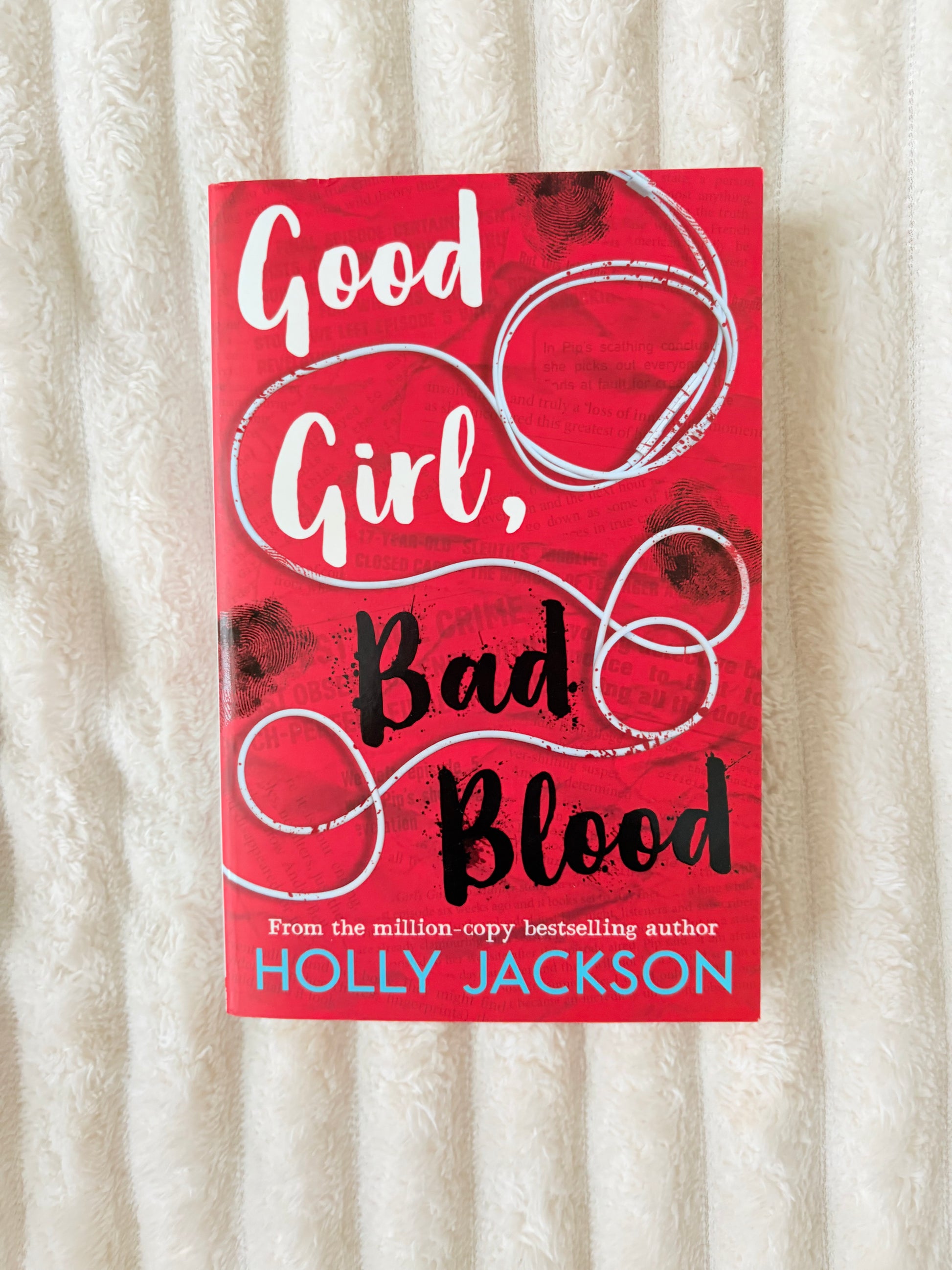 Book cover of 'Good Girl, Bad Blood' by Holly Jackson on a textured surface