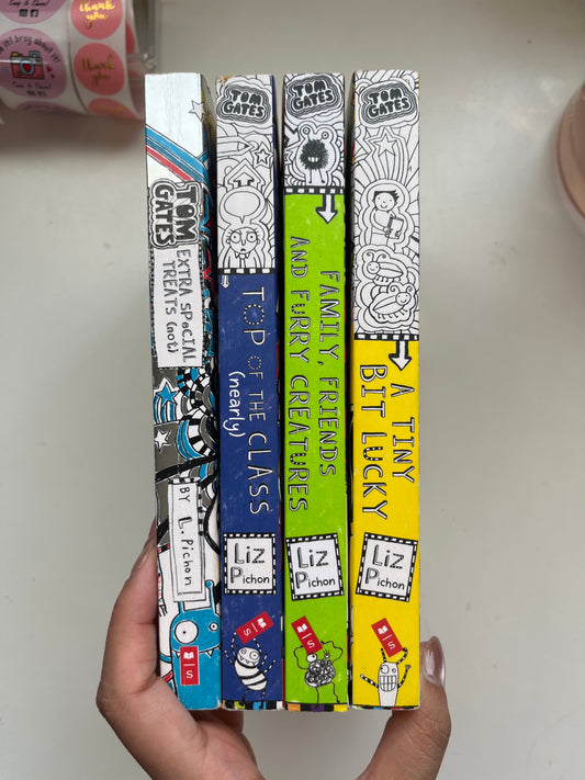 Covers from the Tom Gates series, featuring bold colors, hand-drawn doodles, and funny text.