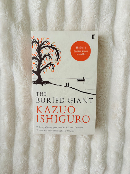 Book titled 'The Buried Giant' by Kazuo Ishiguro on a textured surface